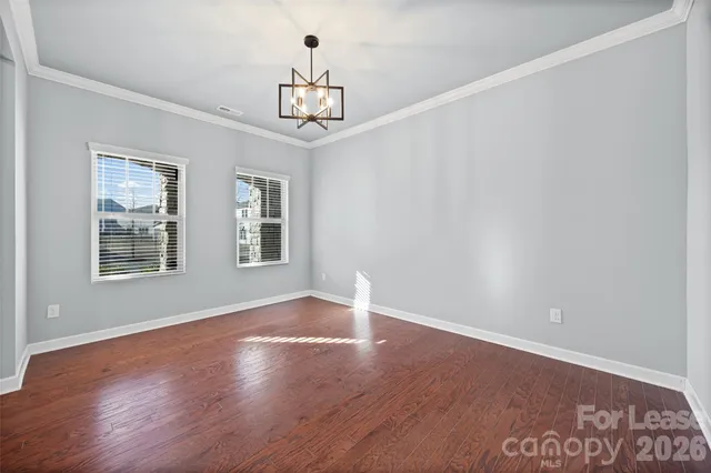 a kitchen with stainless steel appliances granite countertop a sink a stove a refrigerator and island with wooden floor