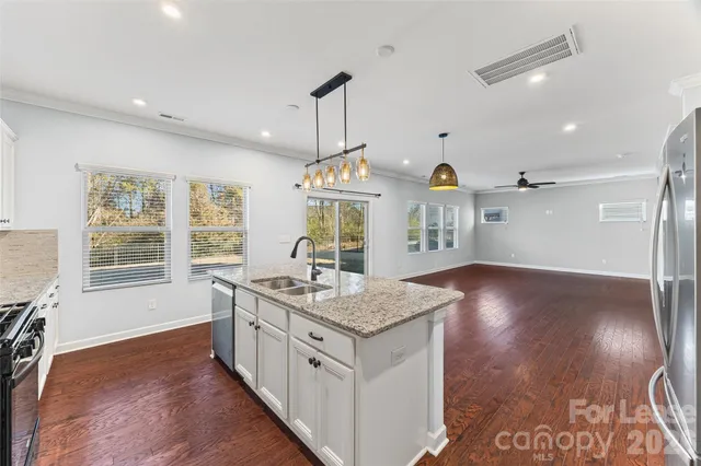 a kitchen with sink cabinets and refrigerator