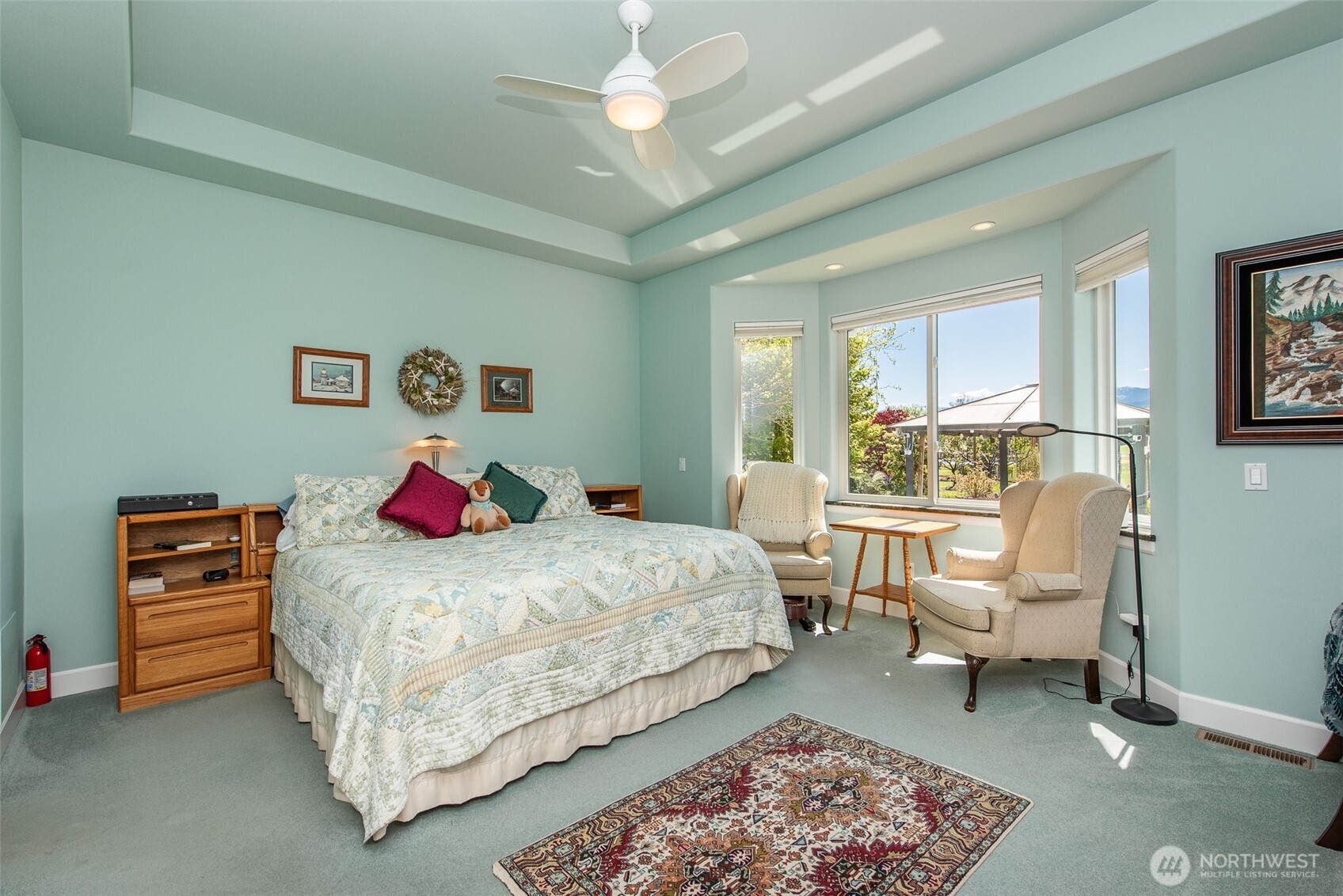 141 Pheasant Run Drive Sequim, WA 98382 - Photo 14 of 40 a bedroom with a bed and a chandelier