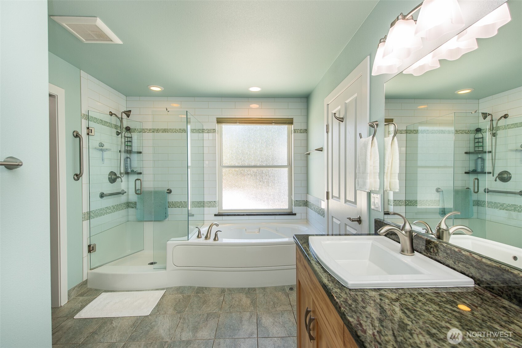 141 Pheasant Run Drive Sequim, WA 98382 - Photo 17 of 40 a spacious bathroom with a granite countertop tub sink shower and mirror