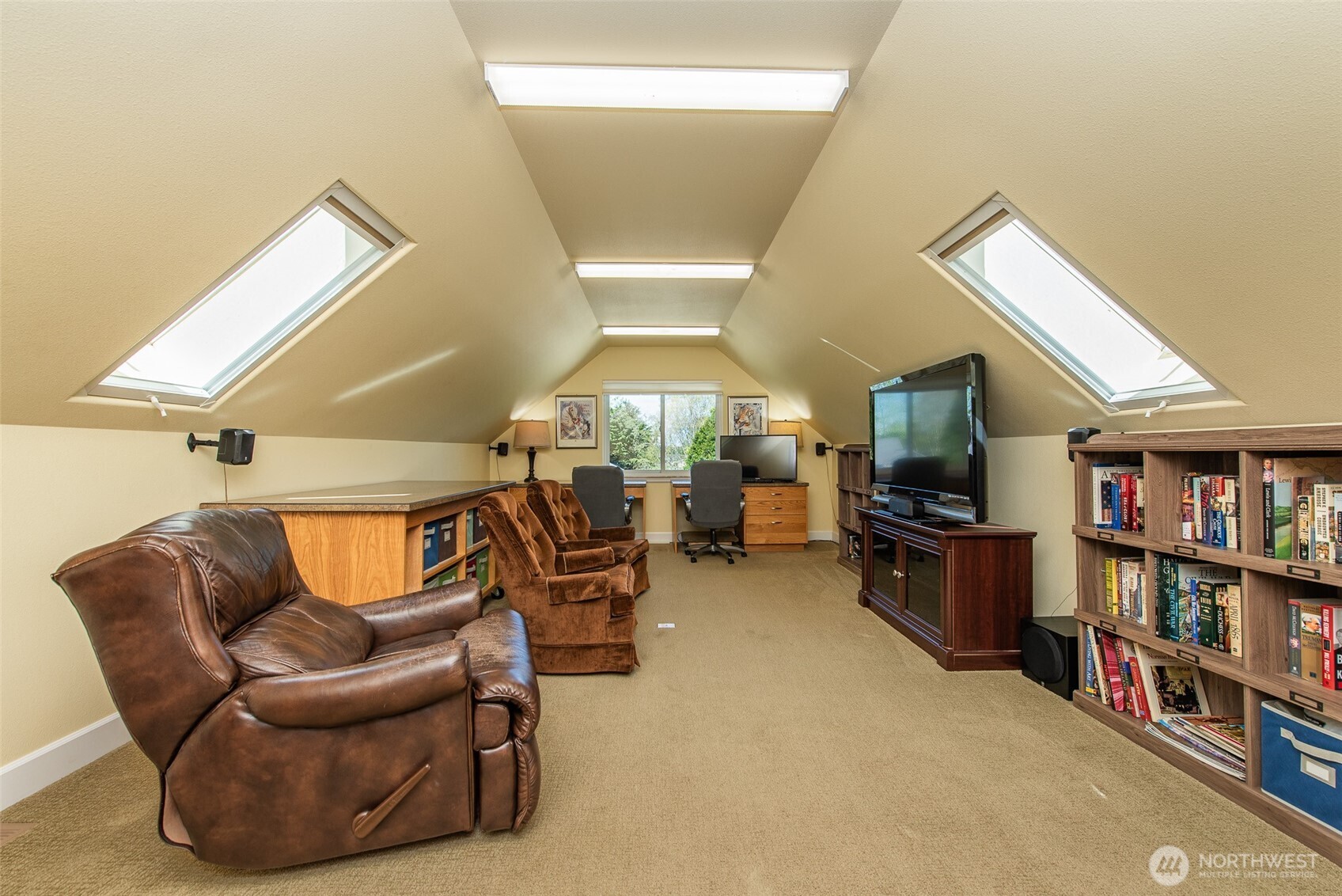 141 Pheasant Run Drive Sequim, WA 98382 - Photo 24 of 40 a living room with furniture a flat screen tv and a bookshelf