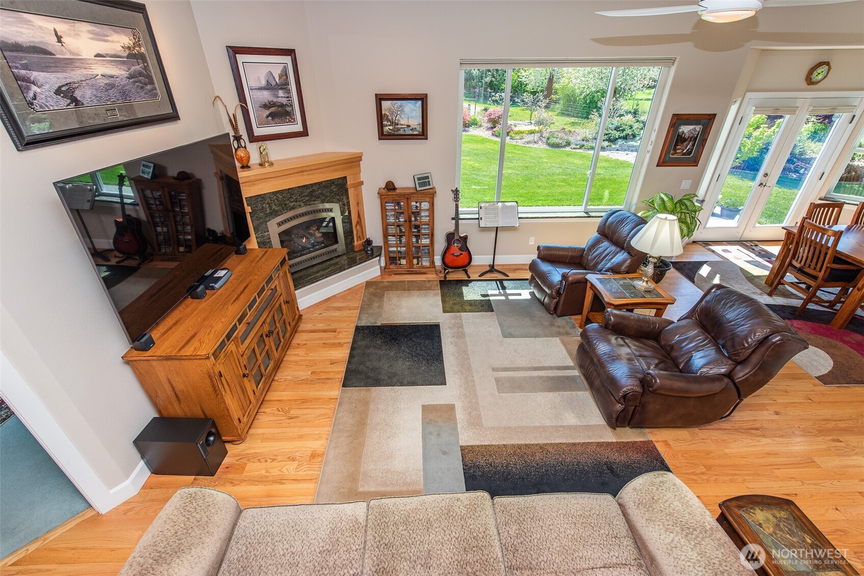 141 Pheasant Run Drive Sequim, WA 98382 - Photo 27 of 40 a living room with furniture a fireplace and a large window