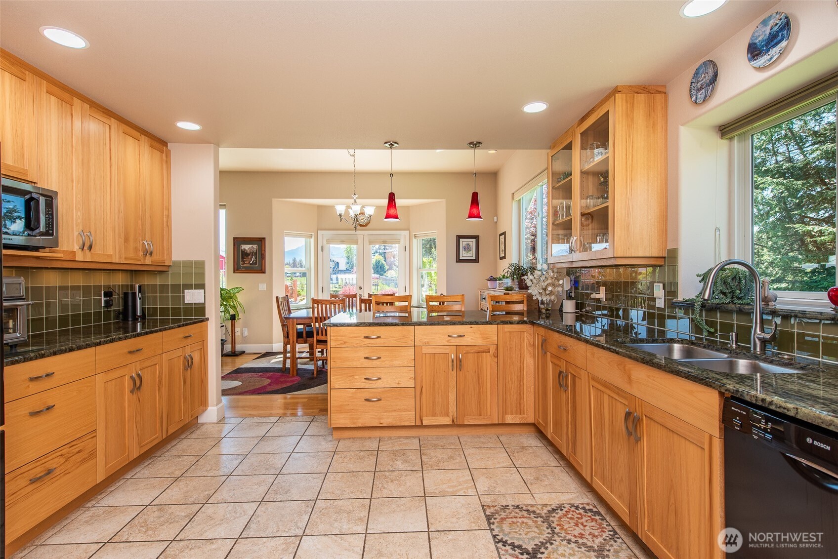 141 Pheasant Run Drive Sequim, WA 98382 - Photo 6 of 40 a kitchen with stainless steel appliances granite countertop a sink and cabinets