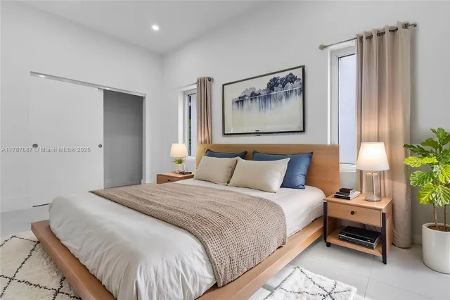 a bedroom with a bed and a painting on the wall