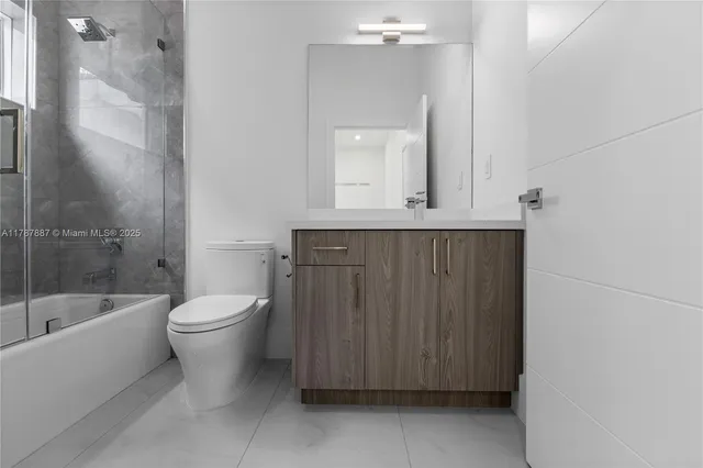 a bathroom with a toilet a sink and bathtub