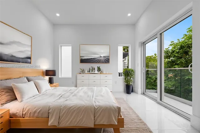 a bedroom with a large bed and a large window