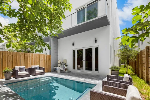 swimming pool view with outdoor seating