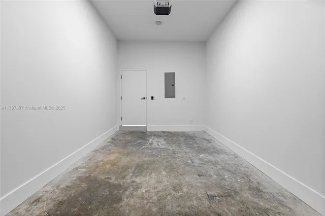 an empty room with a ceiling fan and window