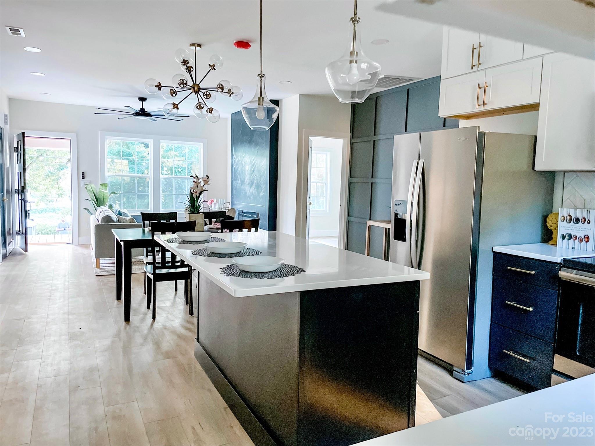 324 South Rhyne Street Gastonia, NC 28054 - Photo 4 of 11 a kitchen with stainless steel appliances a kitchen island hardwood floor sink stove and refrigerator