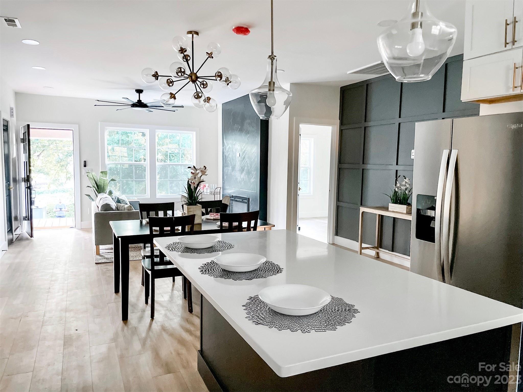 324 South Rhyne Street Gastonia, NC 28054 - Photo 5 of 11 a kitchen with granite countertop a table chairs stove and refrigerator