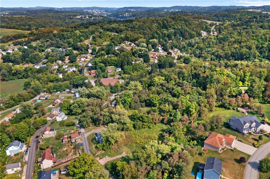 37 B Harding Street Manor, PA 15665 - Photo 2 of 18 an aerial view of a houses with a lush green hillside