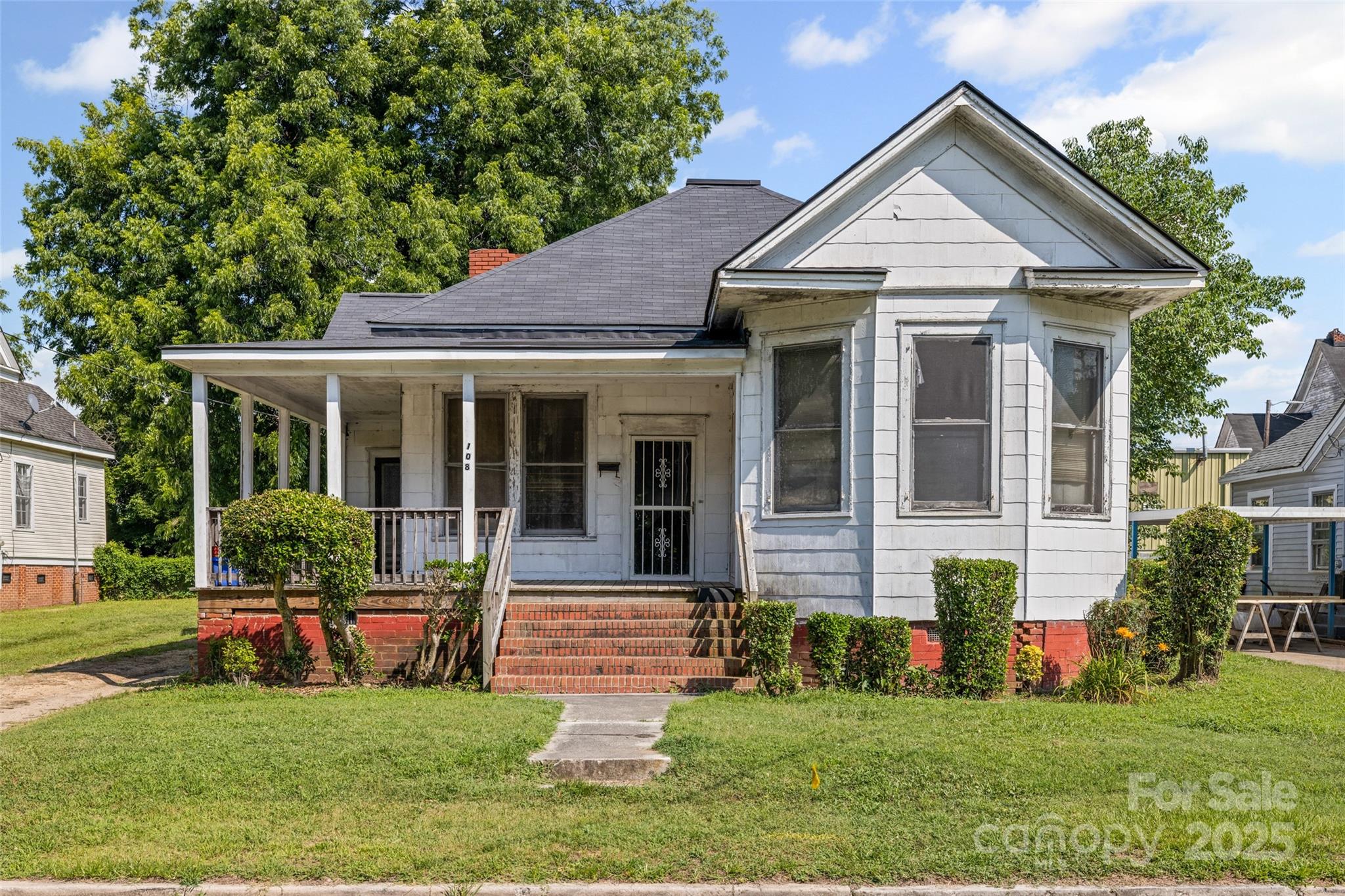 a front view of a house with a yard and porch