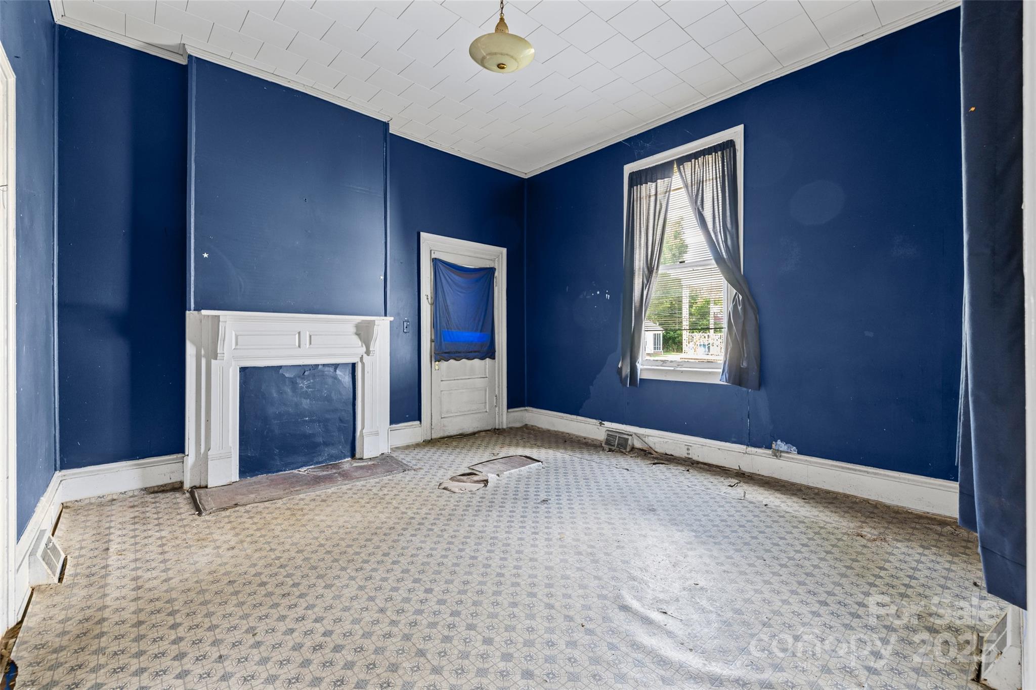 108 Walker Street Chester, SC 29706 - Photo 11 of 31 a view of an empty room with window and fireplace