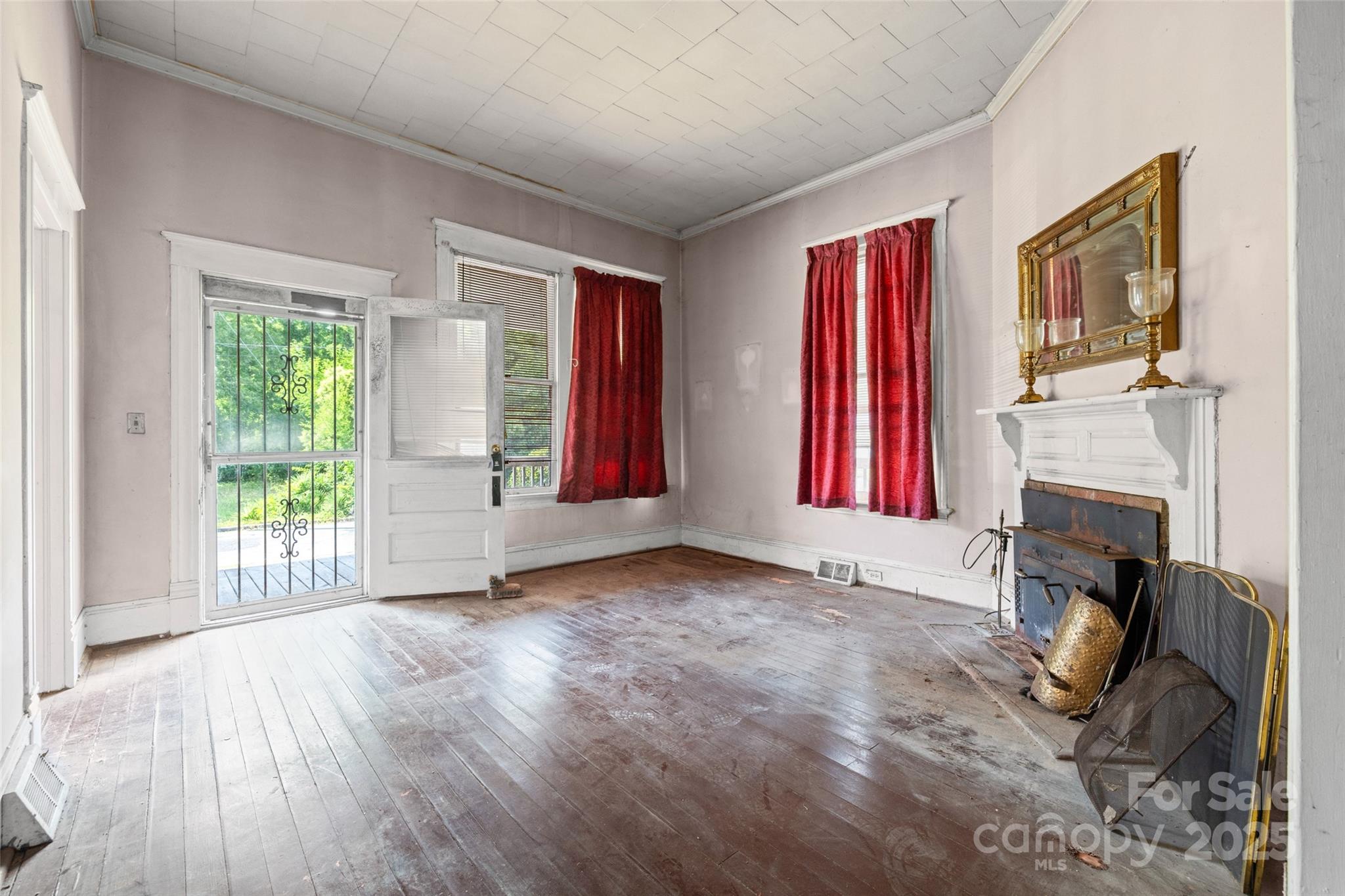 108 Walker Street Chester, SC 29706 - Photo 5 of 31 a view of an empty room with a fireplace and a window