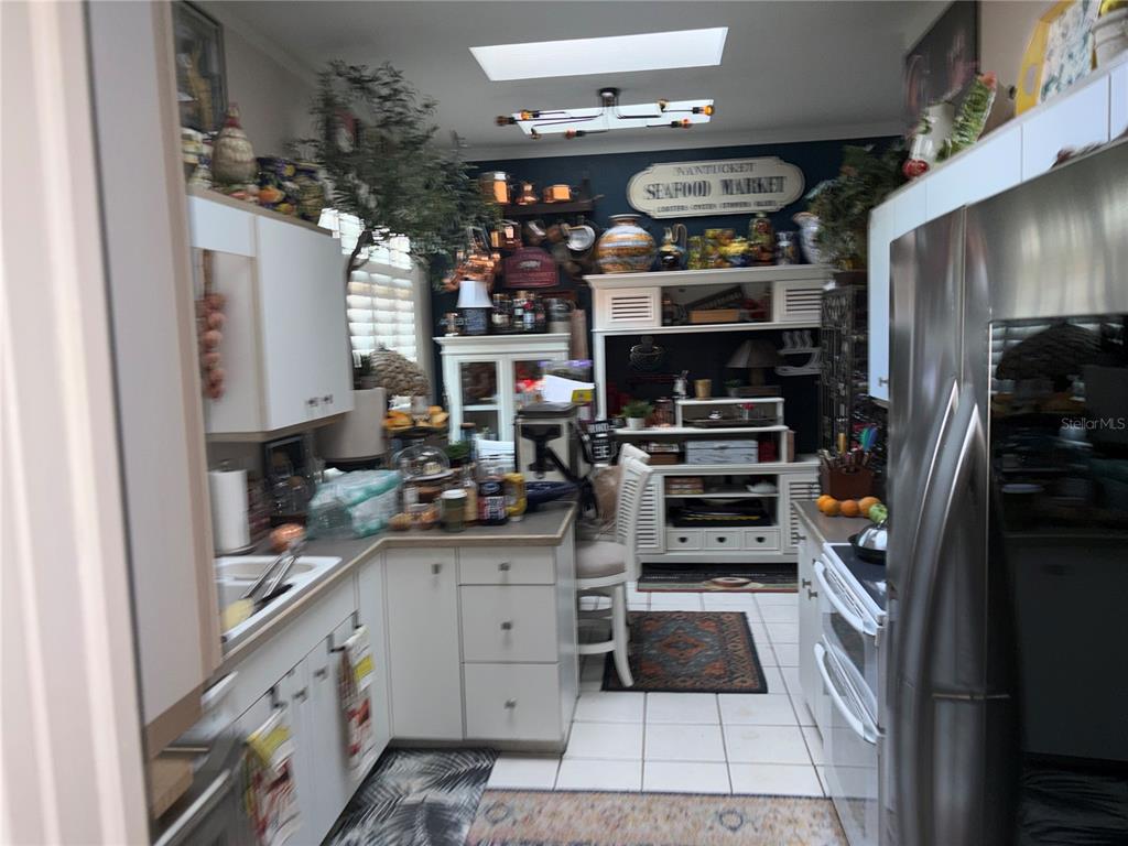 280 Springside Road Longwood, FL 32779 - Photo 27 of 29 a kitchen with granite countertop stainless steel appliances and counter space