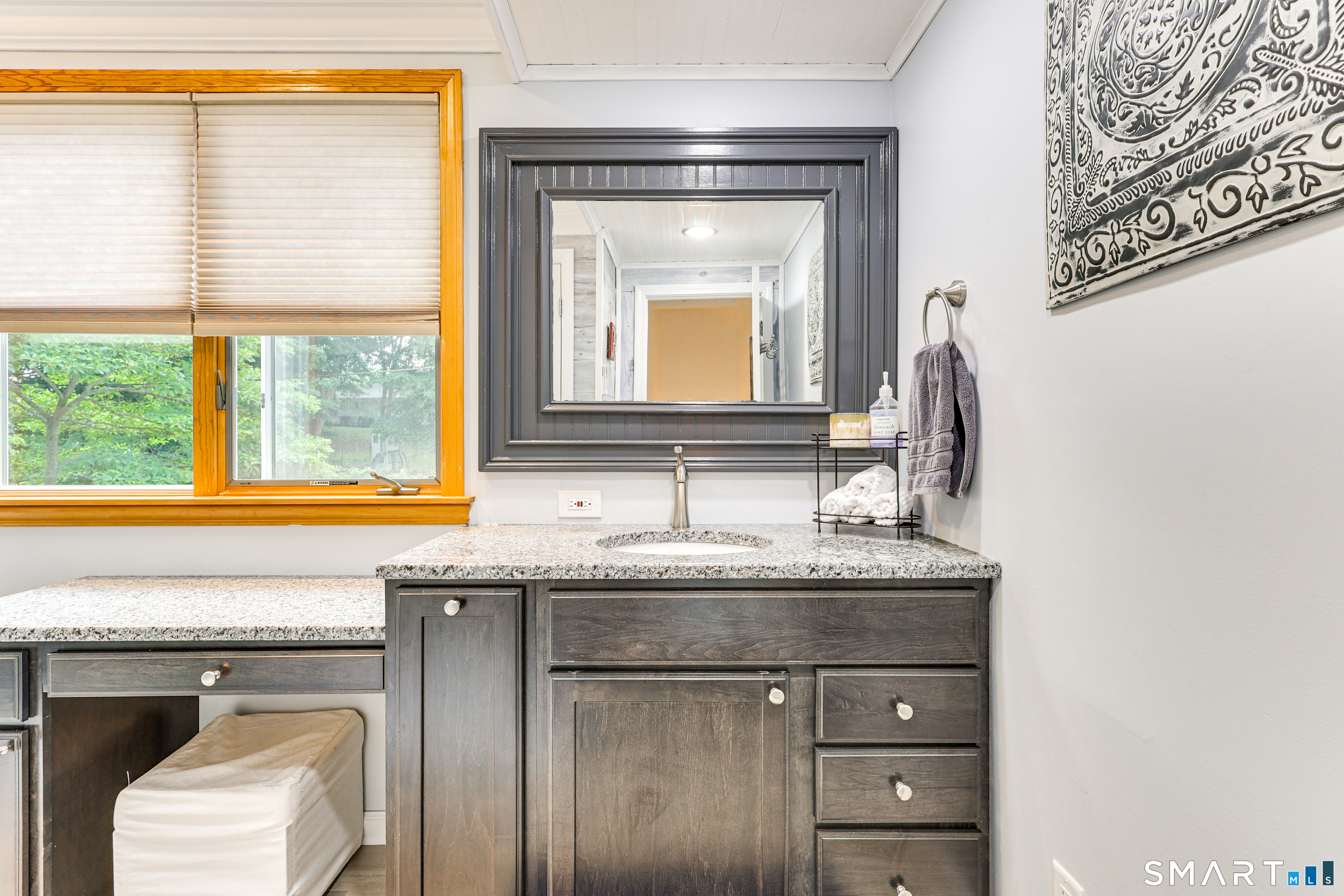 11 Stanton Street Waterford, CT 06385 - Photo 26 of 40 a bathroom with a granite countertop sink a toilet and a window