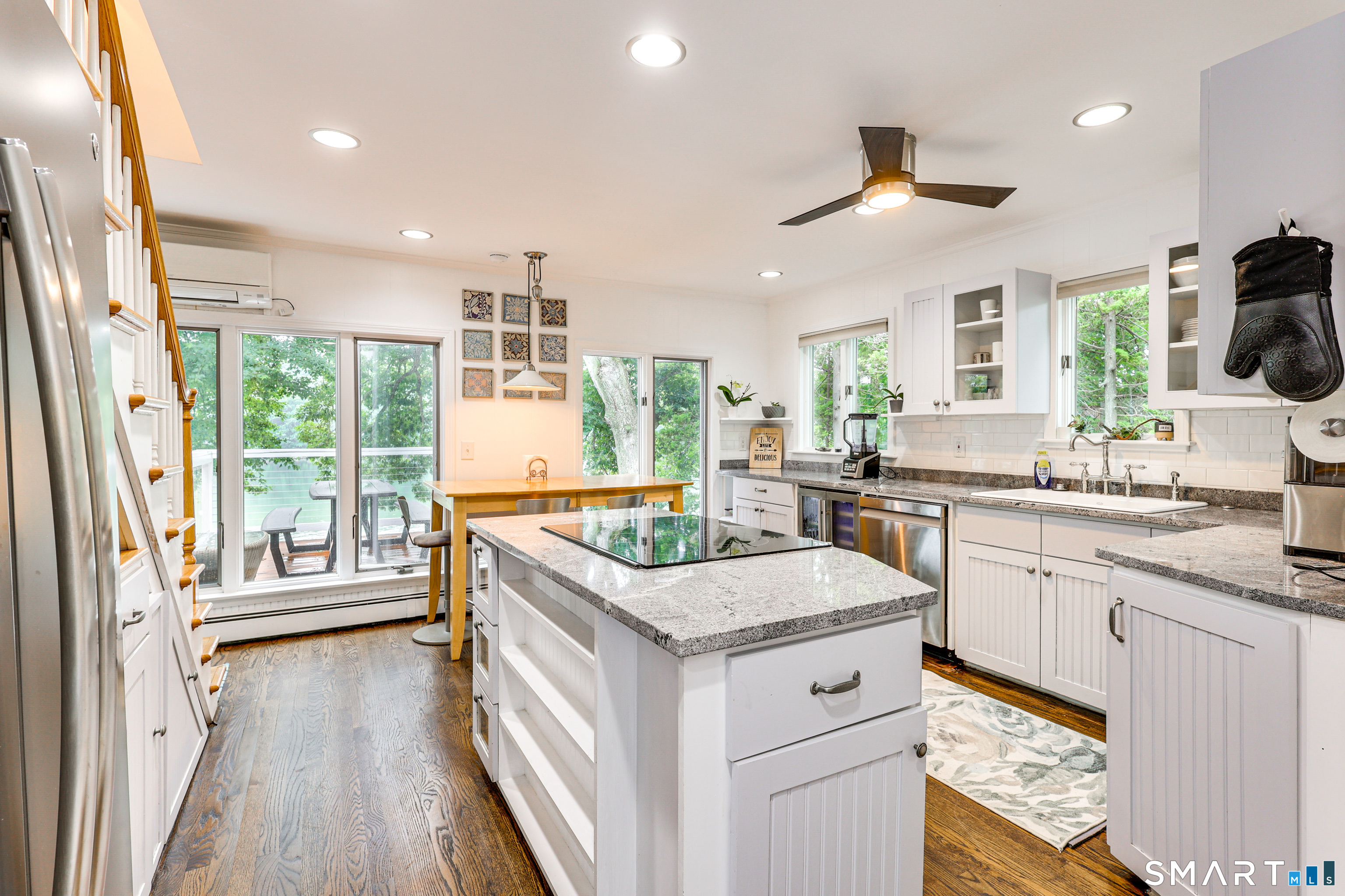 11 Stanton Street Waterford, CT 06385 - Photo 3 of 40 a kitchen with a stove a sink a center island and wooden floor