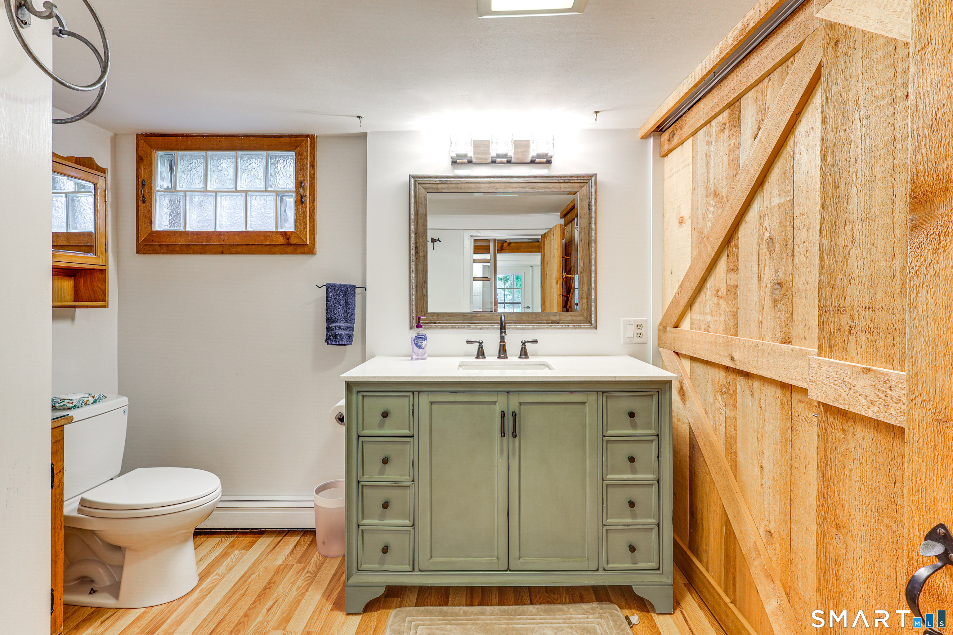 11 Stanton Street Waterford, CT 06385 - Photo 36 of 40 a bathroom with a sink a toilet and a mirror