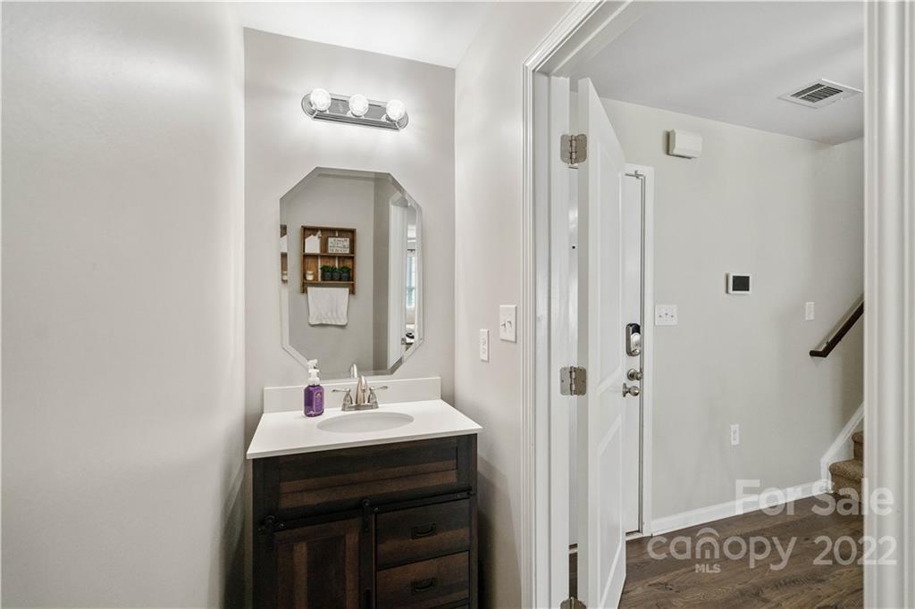 614 Shellbark Drive Concord, NC 28025 - Photo 14 of 30 a bathroom with a sink a mirror a vanity and a shower