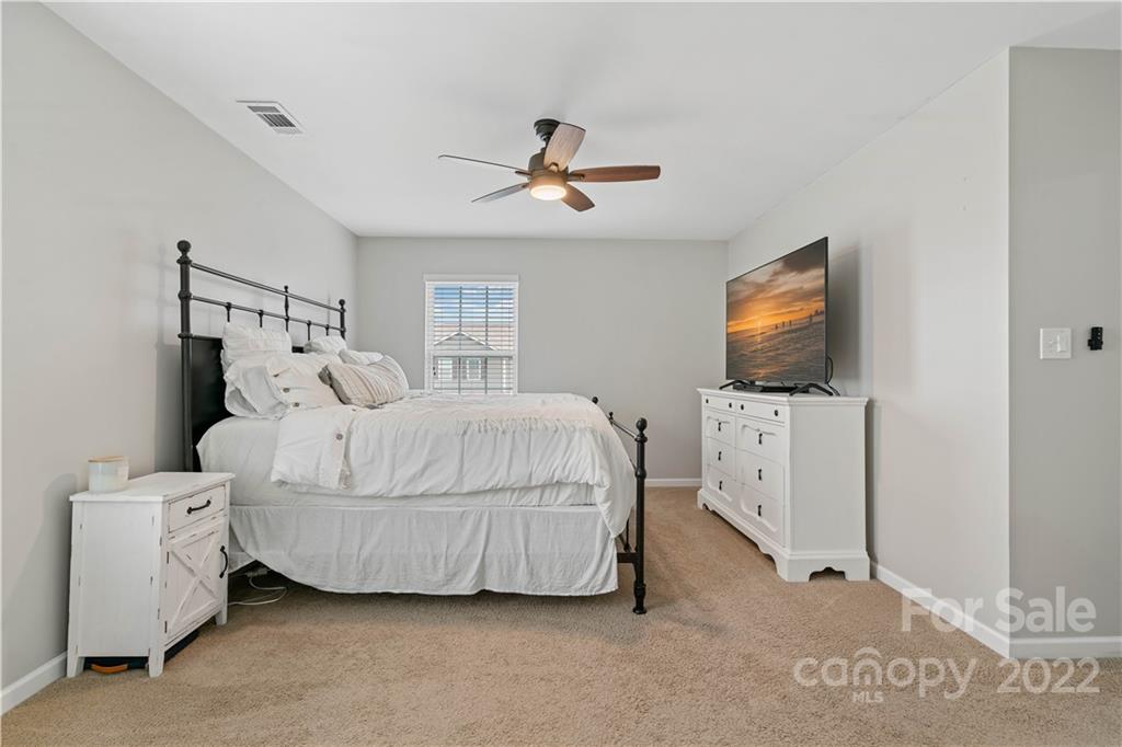 614 Shellbark Drive Concord, NC 28025 - Photo 16 of 30 a bedroom with a bed and a flat screen tv