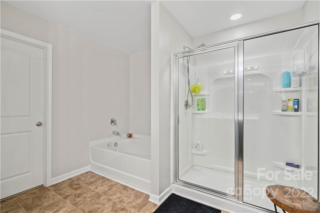 614 Shellbark Drive Concord, NC 28025 - Photo 17 of 30 a bathroom with a shower and a bath tub