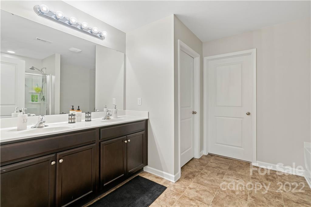 614 Shellbark Drive Concord, NC 28025 - Photo 18 of 30 a bathroom with a double vanity sink and a mirror