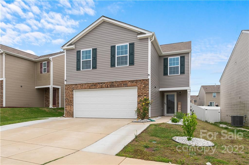 614 Shellbark Drive Concord, NC 28025 - Photo 2 of 30 a front view of a house with a yard and garage