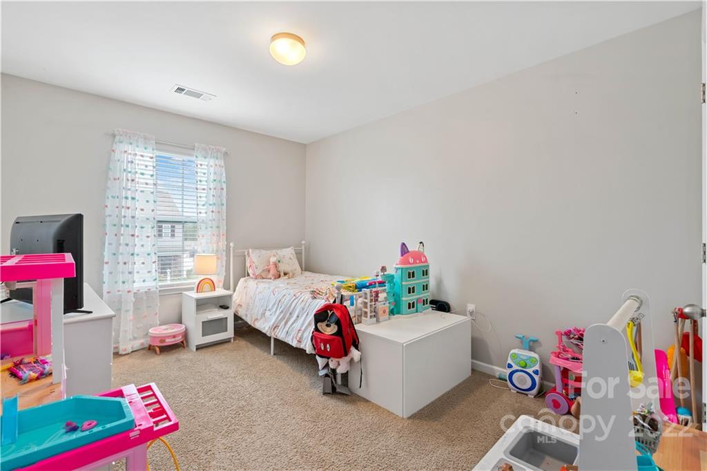 614 Shellbark Drive Concord, NC 28025 - Photo 22 of 30 a bedroom with furniture and a bed