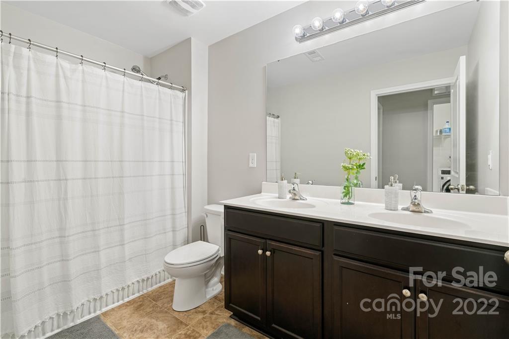 614 Shellbark Drive Concord, NC 28025 - Photo 24 of 30 a bathroom with a double vanity sink toilet and a mirror