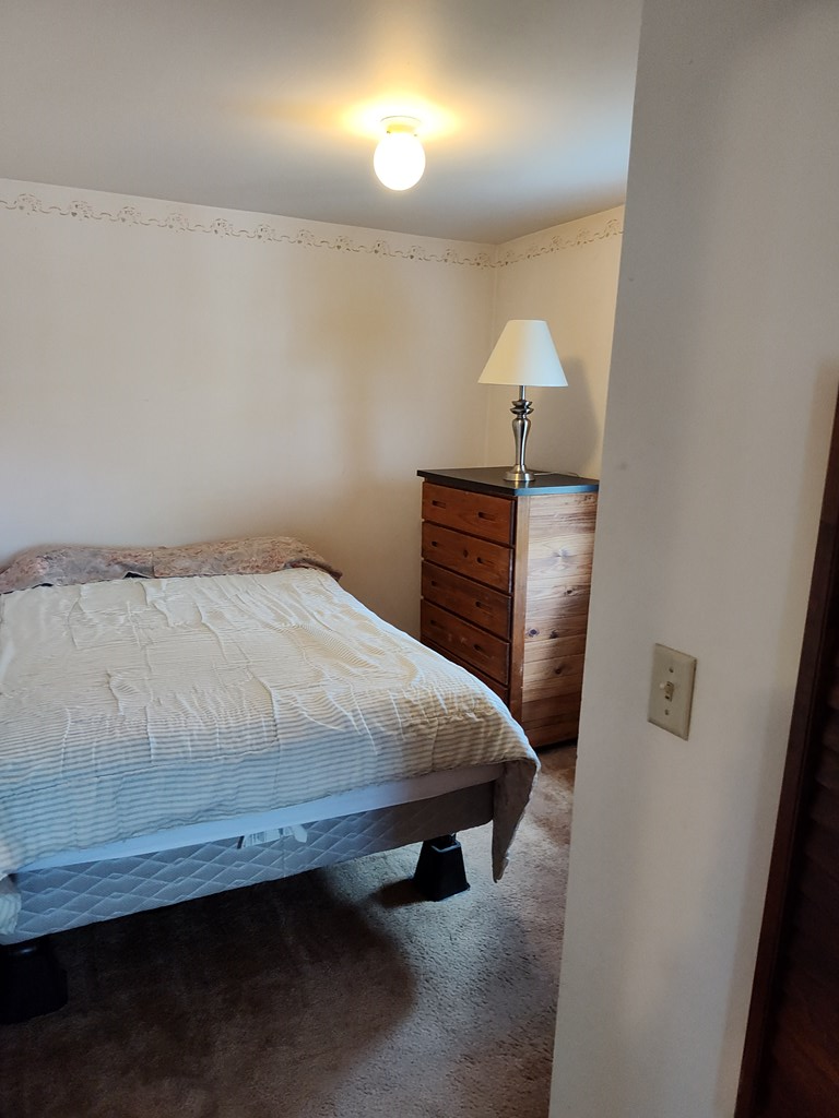 730 Main Street Polk, PA 16342 - Photo 22 of 43 a bed sitting in a bedroom next to a lamp