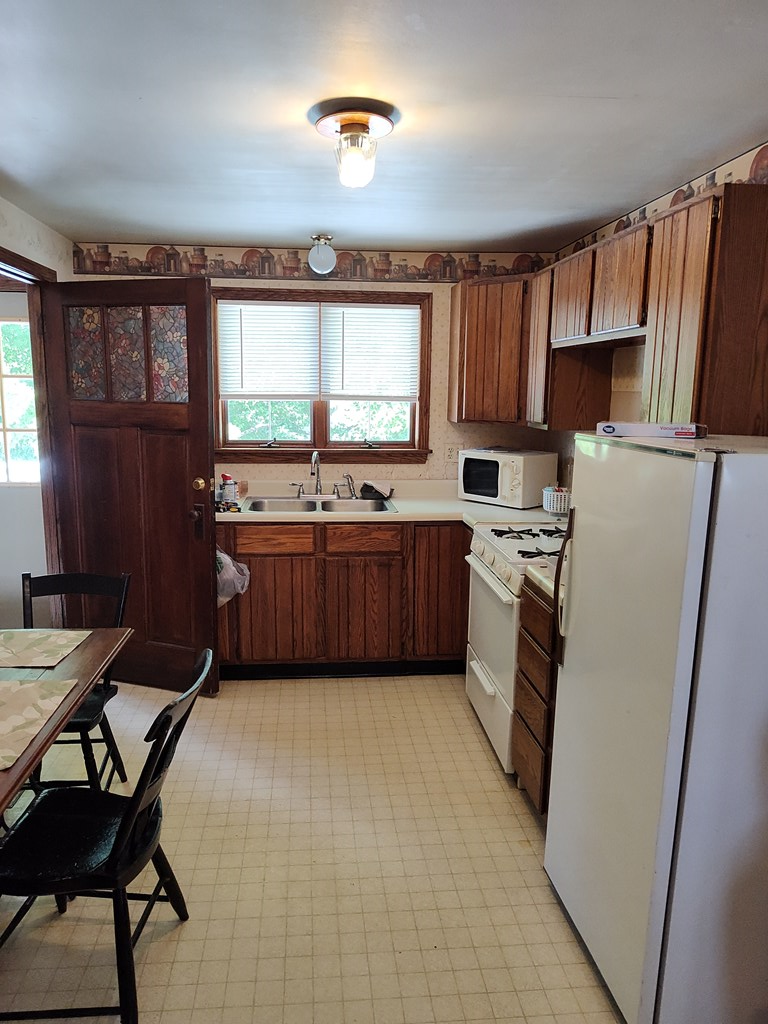 730 Main Street Polk, PA 16342 - Photo 24 of 43 a kitchen with refrigerator and cabinets
