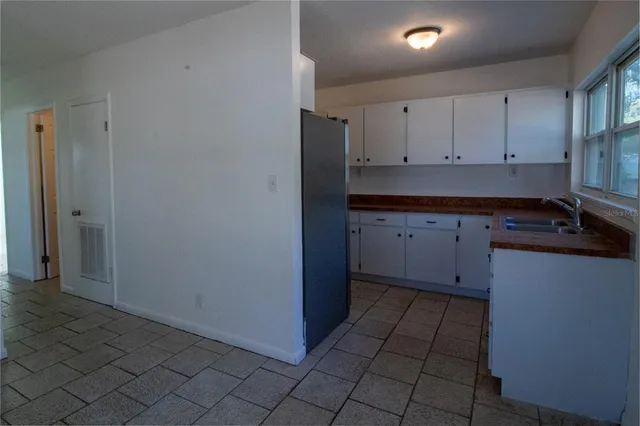 a kitchen with a sink and cabinets