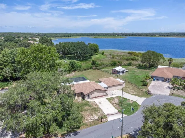 an aerial view of a house with a yard