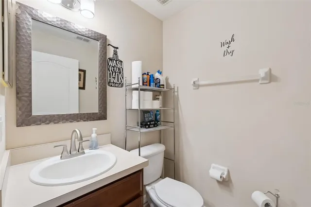 a bathroom with a sink a toilet and a mirror