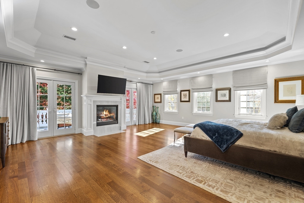 37 Radcliff Road Newton, MA 02468 - Photo 20 of 40 a spacious bedroom with a large bed and a fireplace