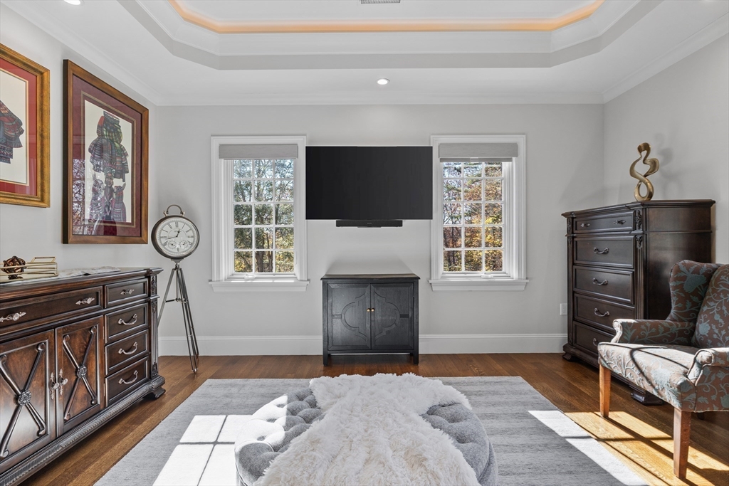 37 Radcliff Road Newton, MA 02468 - Photo 28 of 40 a bedroom with furniture flat screen tv and a fireplace