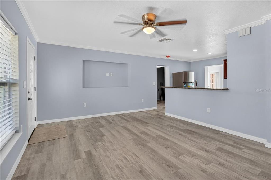 5352 Tangerine Drive New Port Richey, FL 34652 - Photo 11 of 76 a view of a livingroom with a ceiling fan wooden floor and a window