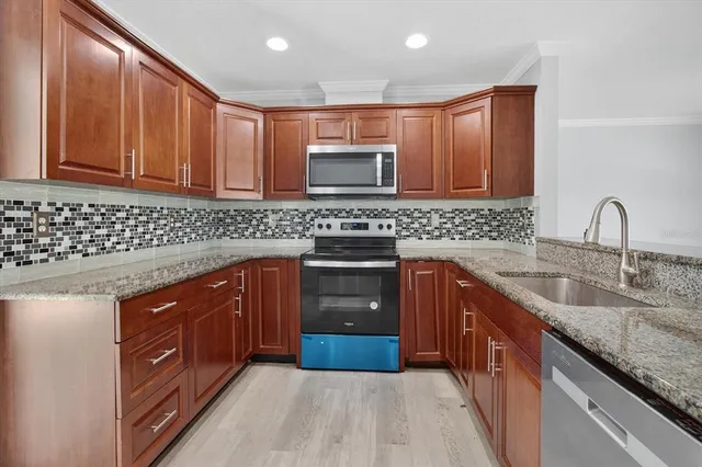 a kitchen with granite countertop cabinets and window