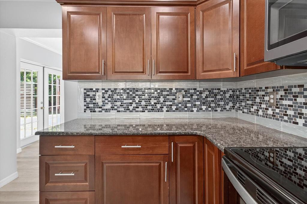 5352 Tangerine Drive New Port Richey, FL 34652 - Photo 17 of 76 a kitchen with granite countertop cabinets and window