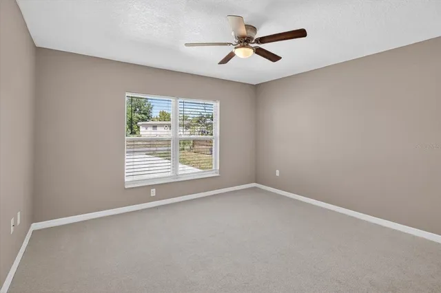 a bathroom with a granite countertop sink a toilet a large mirror and shower