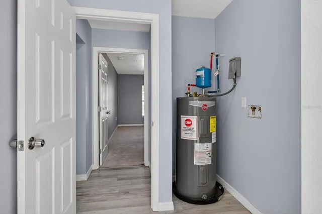 a bathroom with a granite countertop sink a mirror and a bathtub
