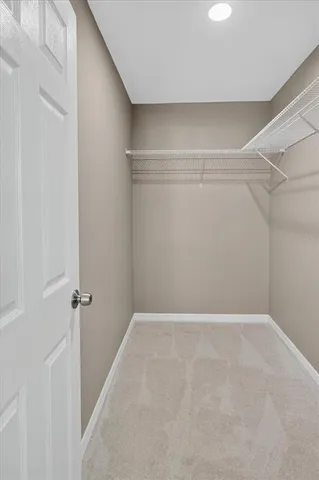 a front view of house with yard and trees in the background