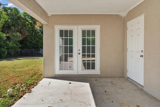 an aerial view of residential houses with outdoor space and trees