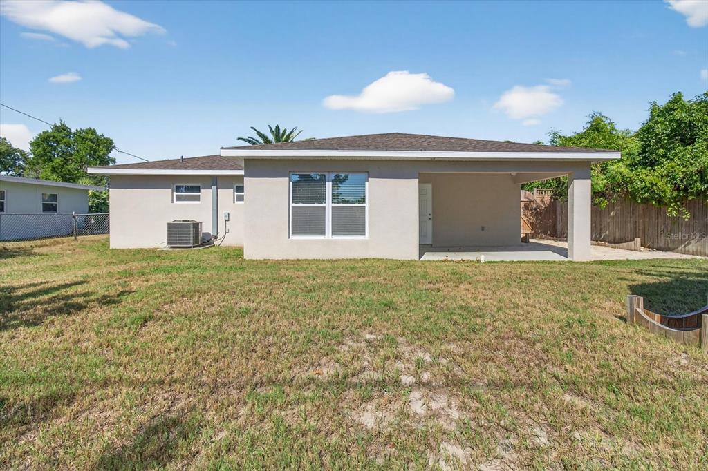 5352 Tangerine Drive New Port Richey, FL 34652 - Photo 49 of 76 a front view of house with yard and trees in the background