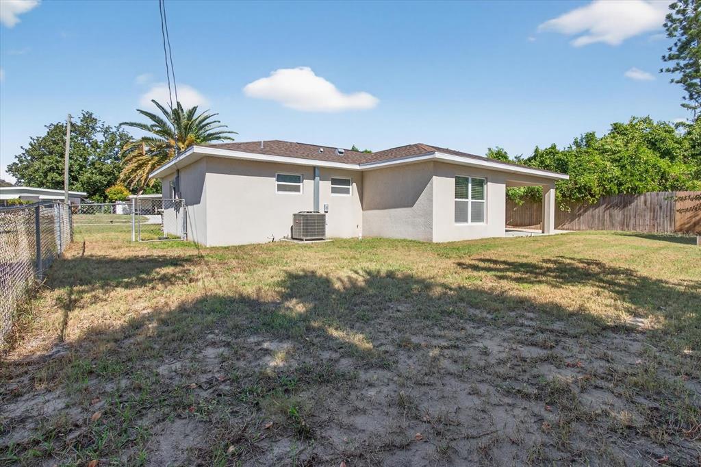 5352 Tangerine Drive New Port Richey, FL 34652 - Photo 51 of 76 a front view of a house with a yard and garage