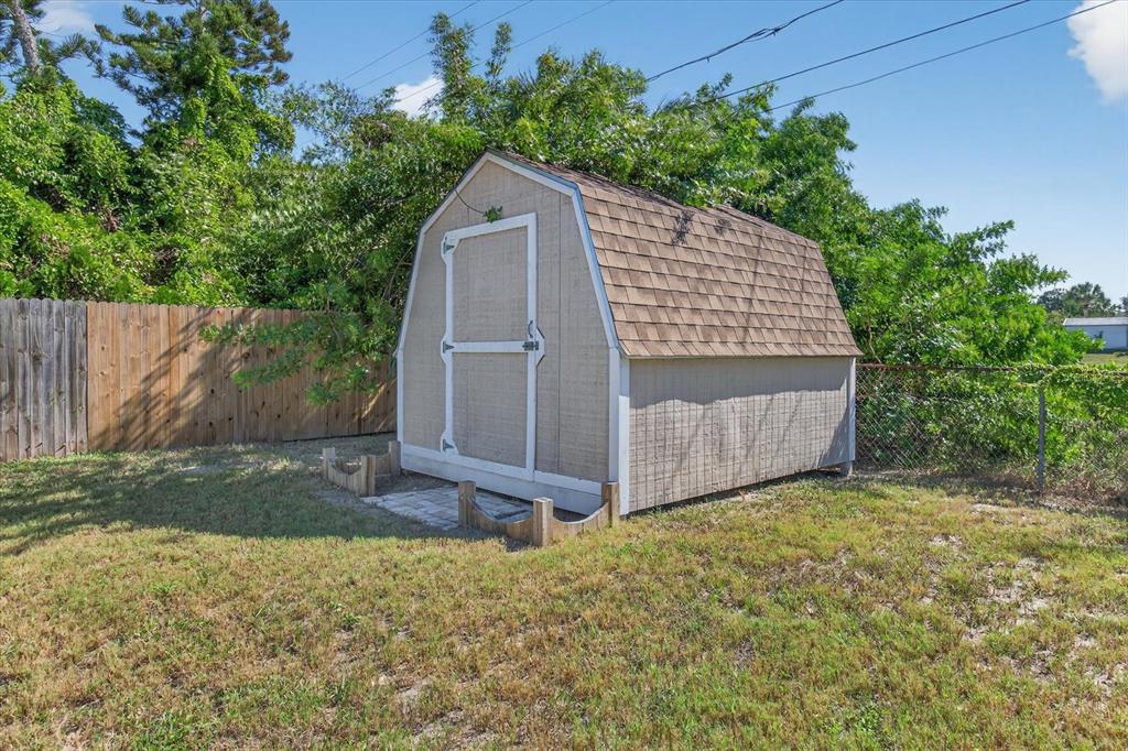 5352 Tangerine Drive New Port Richey, FL 34652 - Photo 54 of 76 a view of backyard with small cabin and wooden fence