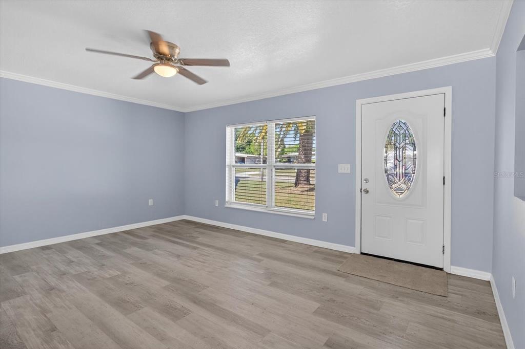 5352 Tangerine Drive New Port Richey, FL 34652 - Photo 7 of 76 wooden floor in an empty room with a window