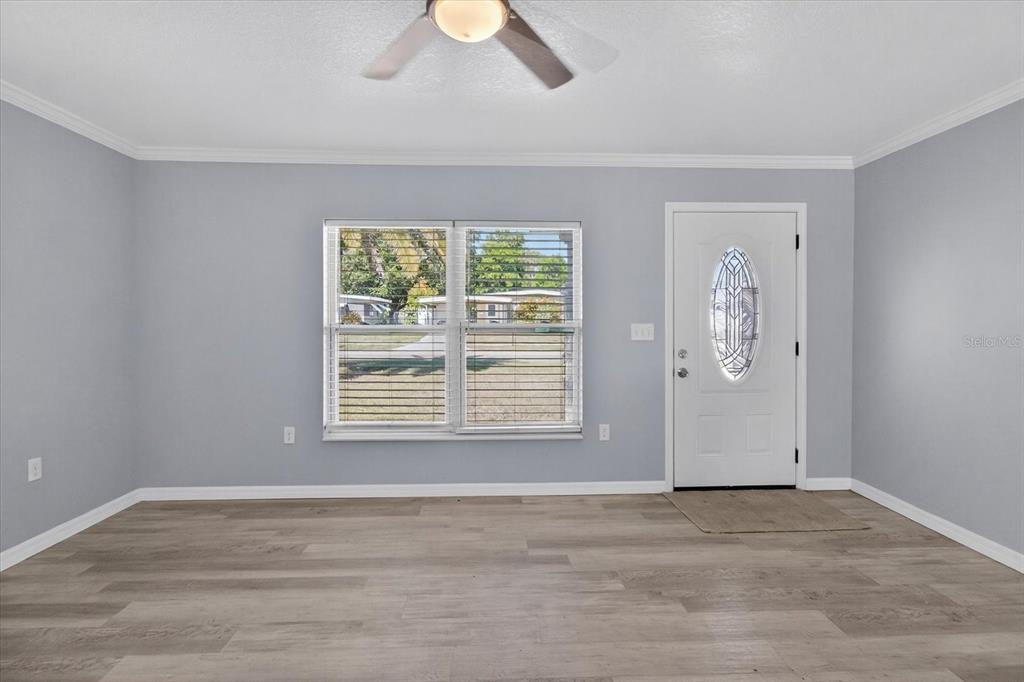 5352 Tangerine Drive New Port Richey, FL 34652 - Photo 8 of 76 a view of an empty room with a window and wooden floor