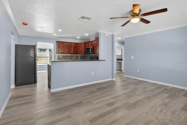 a kitchen with stainless steel appliances granite countertop wooden cabinets and a stove top oven