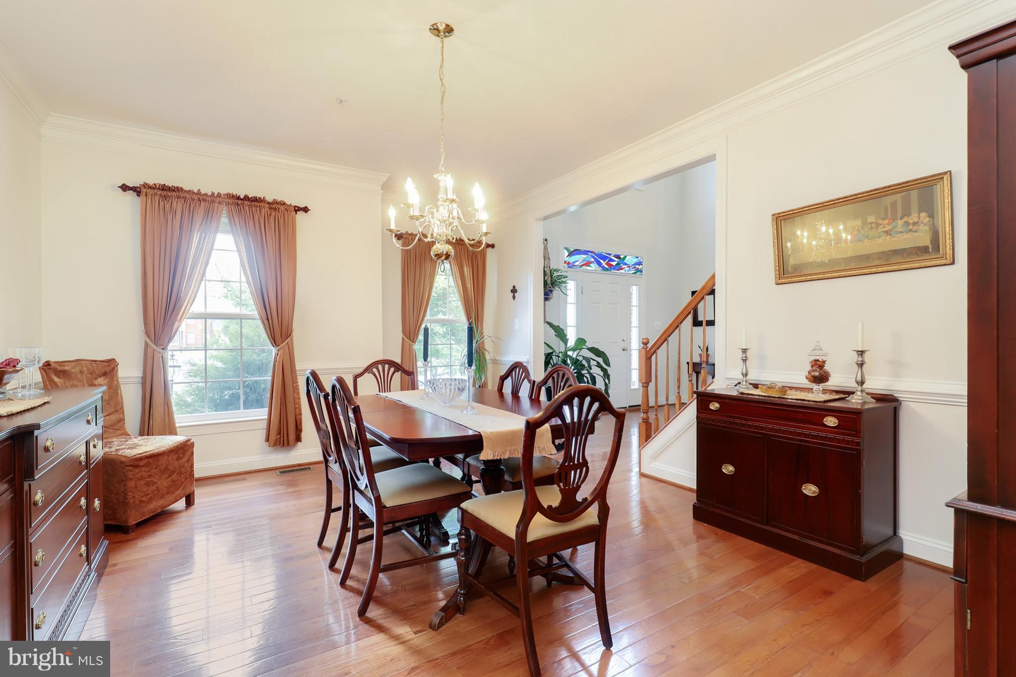 6905 Ironbridge Lane Laurel, MD 20707 - Photo 12 of 30 a view of a dining room with furniture and chandelier